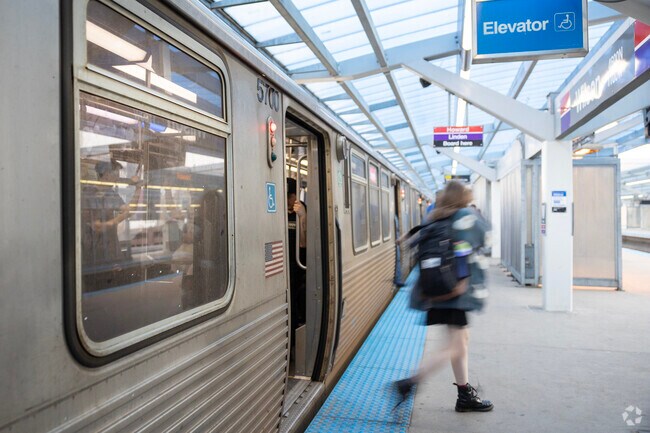 Passengers quickly commute around Chicago at Sheridan Park's CTA Wilson Red Line Stop.