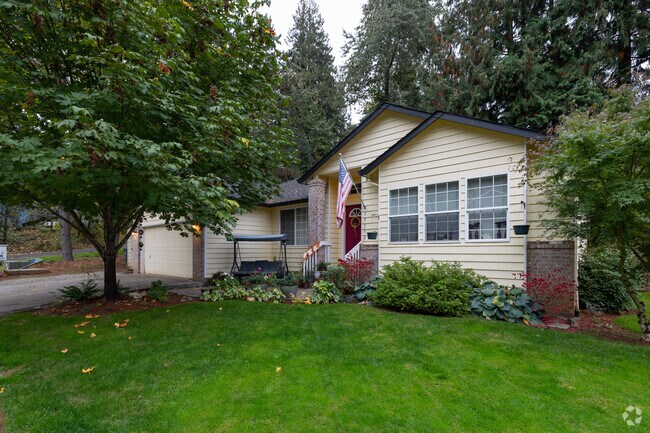 A home is tucked away between large trees on Loundree Dr in Sandy.