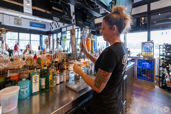 A bartender pours a drink at Gibb's Garage Bar and Grille in Hampton.