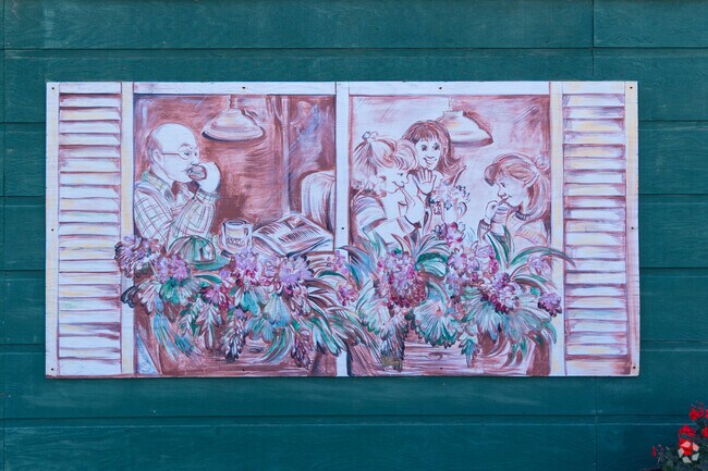 A mural with flowers decorates a building in downtown Ossian.