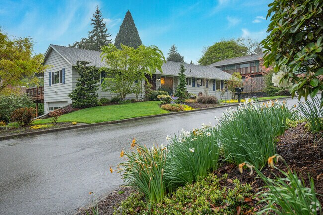 Mid-Century Rancher sits beautifully landscaped on a lot in the Markham, Portland neighborhood.