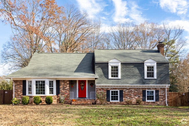 A quaint Cape Cod style home nestled among the trees in Tuckahoe Village, Virginia