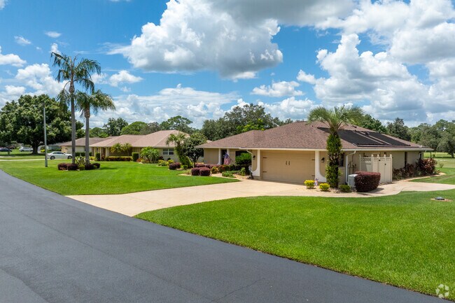 Larger Mediterranean style single-family homes line the golf course in Golf Hammock.