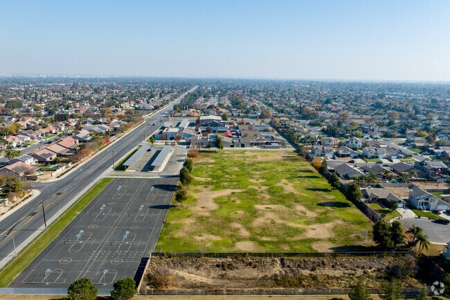 The basketball courts at Freedom Middle school are on the Westside of teh School grounds.