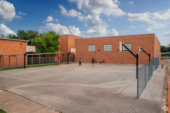 San Antonio students attending Olmos Elementary School have  a basketball court for recess.