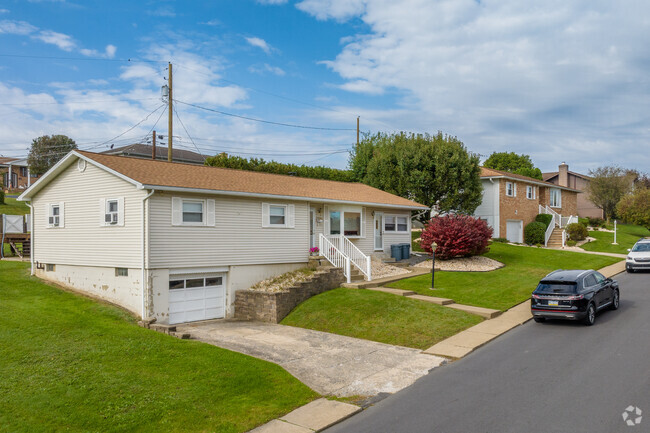 Ranch homes built into the rolling hills feature a lower level garage and spacious yards.
