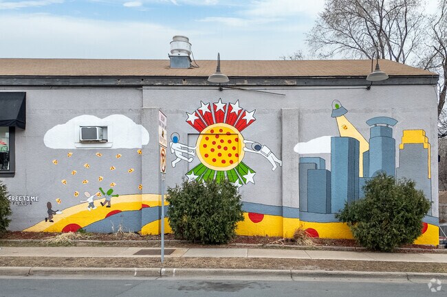 This colorful mural adorns the side of Parkway Pizza in Bronx Park.