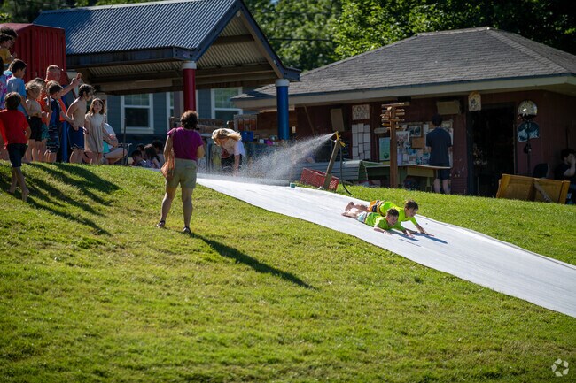 Kids cool off on a slip and slide in Brooklyn Park on SE Milwaukie Ave in Portland.