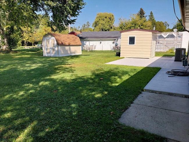 Two freshly painted sheds with new patio