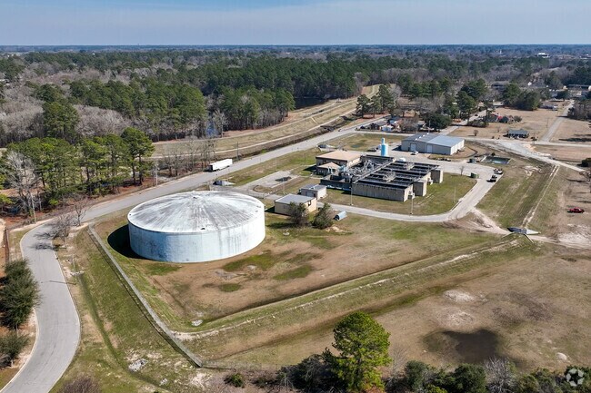 A 13 foot dike runs to the north of the water treatment plant in Lumberton as a result of terrible flooding from recent hurricanes - it serves double duty as a greenway trail.
