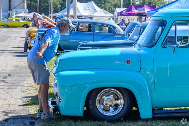 A hot rod owner puts final touches on his F-100 at a street rod show near Eastwood.