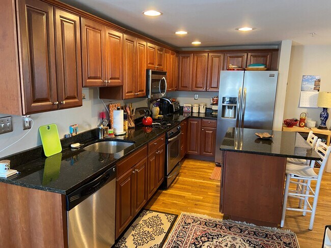 chef's kitchen with granite, stainless appliances, island and plenty of storage!