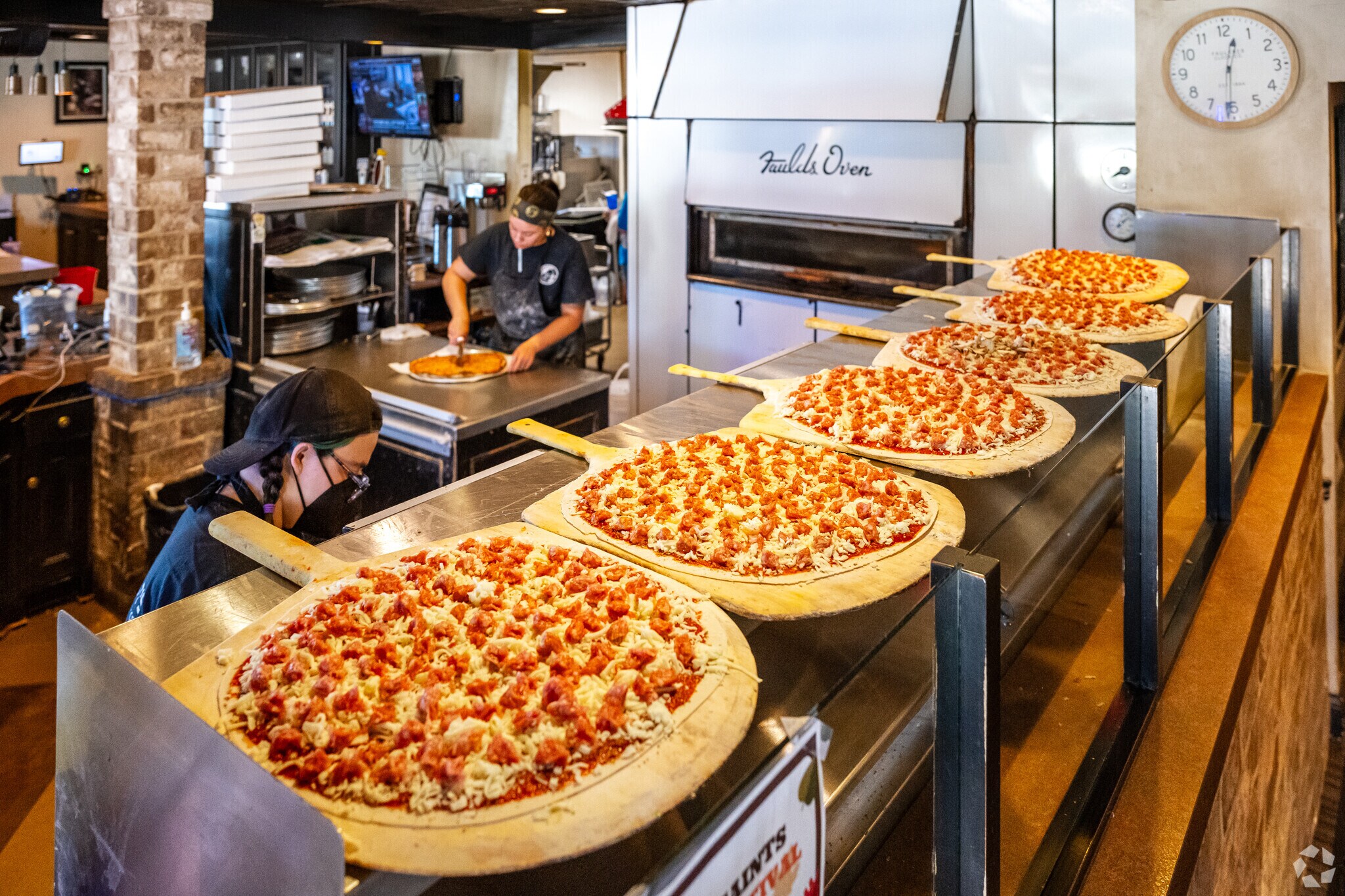 Freshly made pizzas at Cranky Pat's Pizzeria in Oak Grove and ready for the oven.