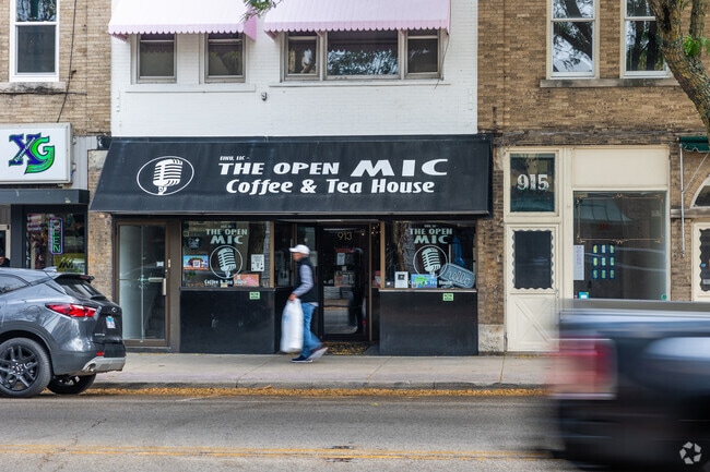 A man walks by The Open Mic Coffee and Tea House which hosts local talent with coffee.