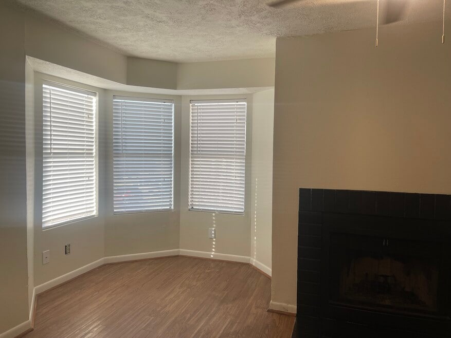 Bay window in living room with fireplace