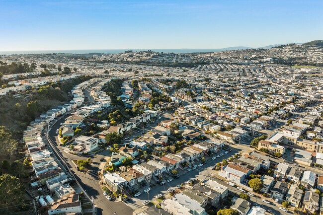 Crocker neighborhood's curved streets showcase dense, classic row homes with cityscape views.