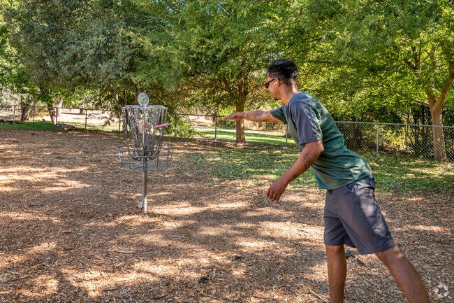 A resident is practicing his disc golf putting skills in Orangevale.