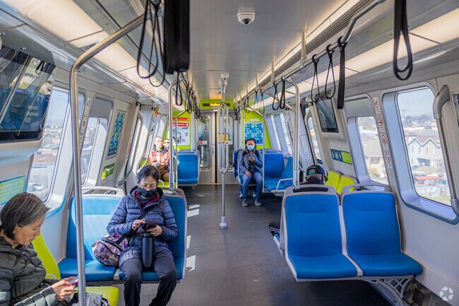 Busy mornings at the Coliseum BART Station show the neighborhood’s commuter vibe.