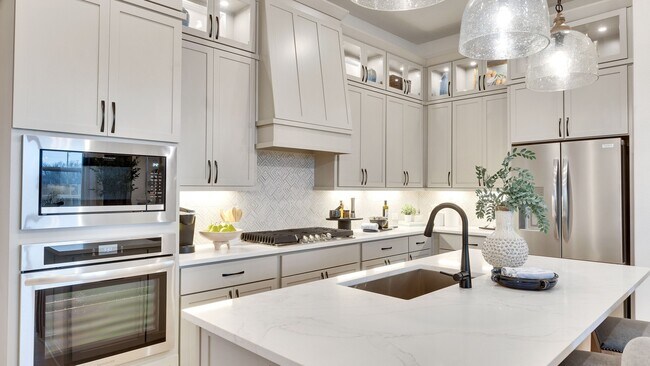 Luxurious Spring Creek kitchen featuring marble countertops and chic stainless appliances.