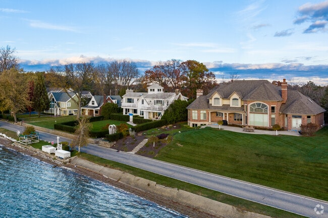 Waterfront homes in Orchard Lake Village offer serene lake views and private access to crystal-clear waters.