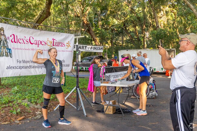 Runners take photo ops at Alex's Capes and Tiaras 5K.
