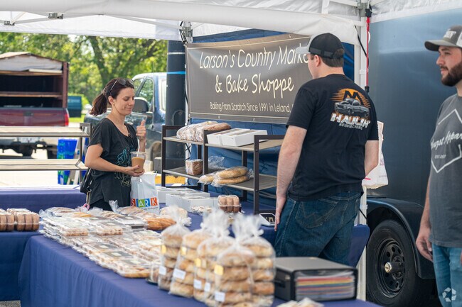 A satisfied shopper gives a thumbs-up to a vender at the Aurora Farmers Market.
