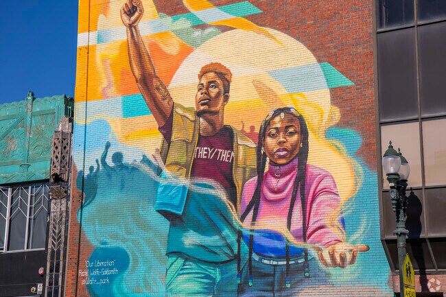 A beautiful mural by Rachel Wolfe Goldsmith decorates a building on the streets of Uptown.