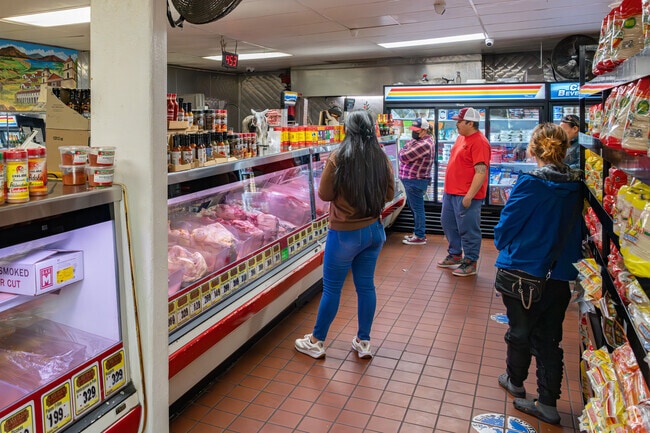 A group of Lakeview residents wait their turn at the La Villa Meat Market counter.