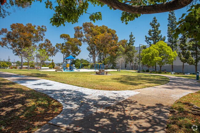 A sand pit and play structures make Dennis V. Allen Park a family-friendly destination.