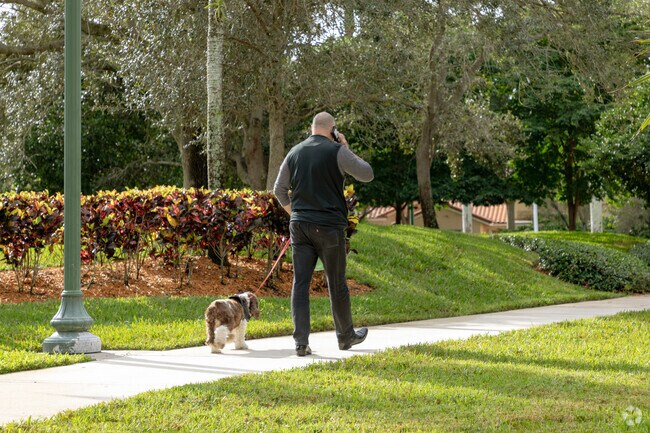 A man and his dog stroll the streets of Country Isle in Weston, FL.