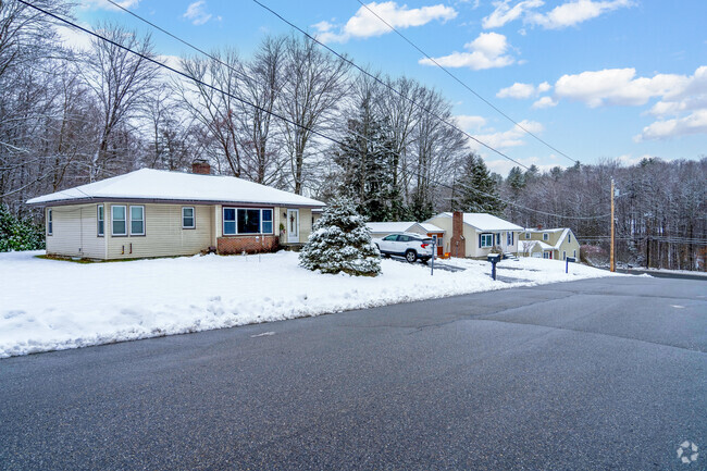 A row of modest ranch style homes in South End are blanketed in snow with ample yard space.