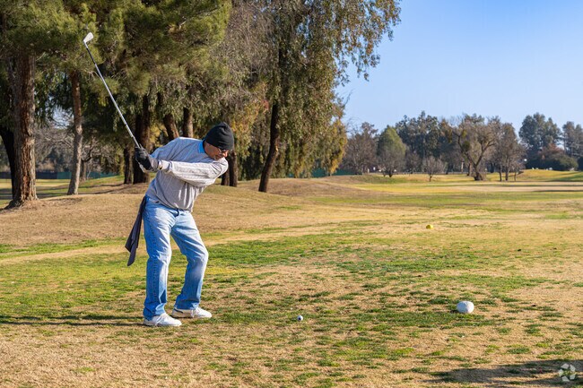 A local golfer tees off for the first hole at Lemoore Golf Course.