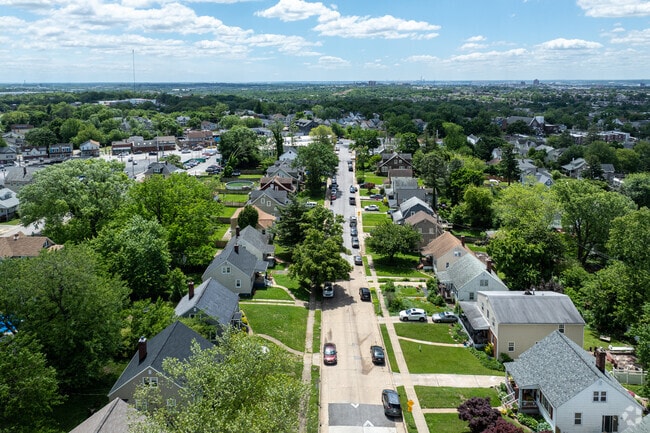 Streets in Wilson Heights range from two lane to narrow single lanes, and are lined with trees.