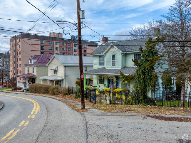 Older homes stand on Washington Street, while the Bentley Towers stands in the background.