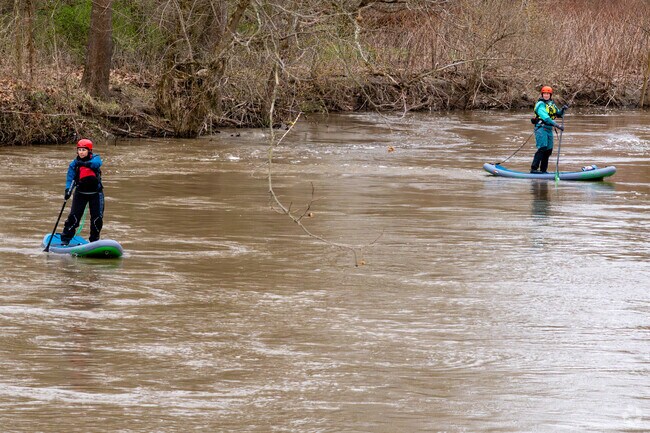 Stand Up Paddle Boarders navigate the Cuyahoga River in the Cuyahoga Valley National Park near the Valley View neighborhood.