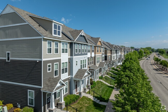 Rows of modern townhomes stretch along Old Hwy 8 NW in New Brighton.