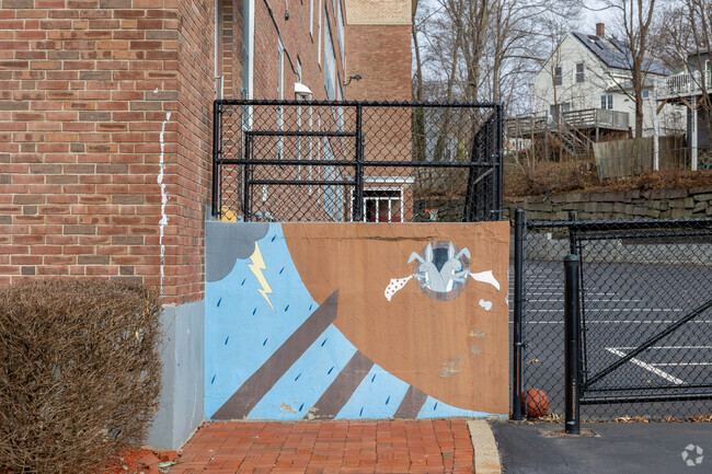 A playful mural is painted on the facade of Sacred Heart Elementary School in Weymouth.