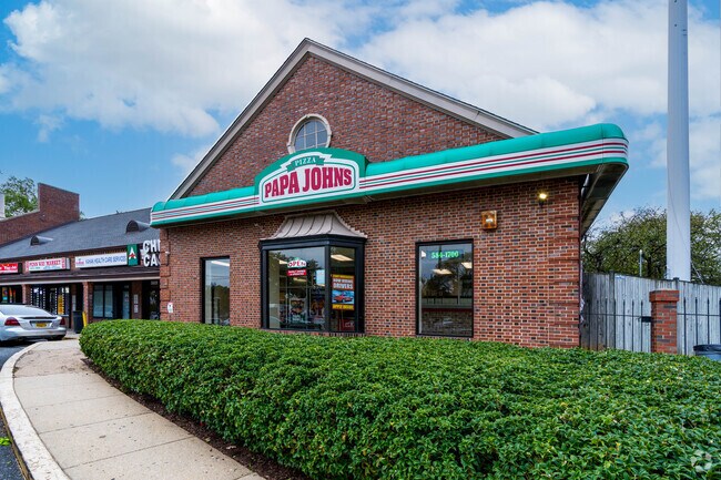 The exterior of Papa John's pizza shop faces a Fairfax Village street.