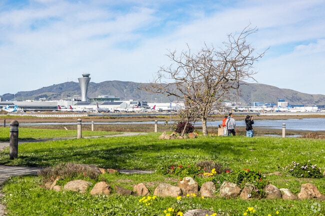 People flock to watch airplanes land from Bayfront Park, near Downtown Millbrae.