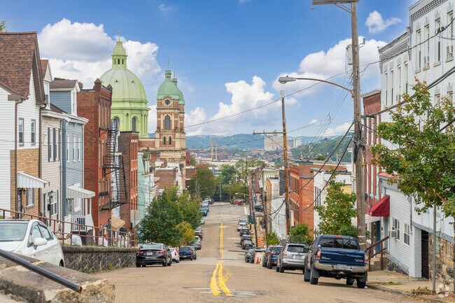 A streetscape in Polish Hill gives a view across a valley over the Allegheny River.