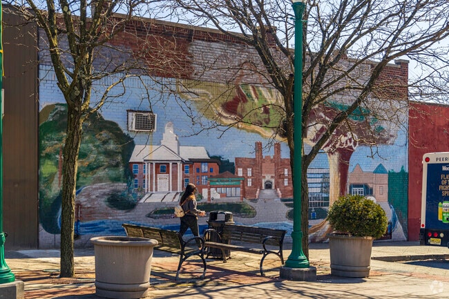 There are colorful murals located at an open plaza off of Cedar Ln in Teaneck, NJ.