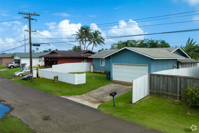 Older single family homes with fenced yards are common in Kapaa.