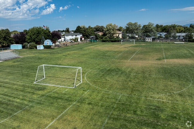 Soccer fields at West Jordan High School are surrounded by mature trees.