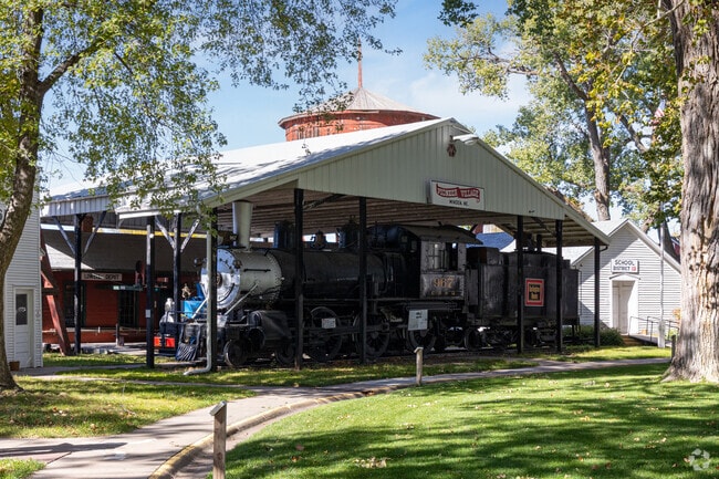 Outdoor exhibits at Pioneer Village bring rail and farm history into view.