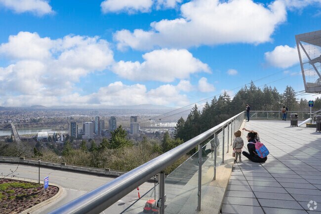 Travelers enjoy views of South Waterfront and the Willamette River from the Tram Station at OHSU.