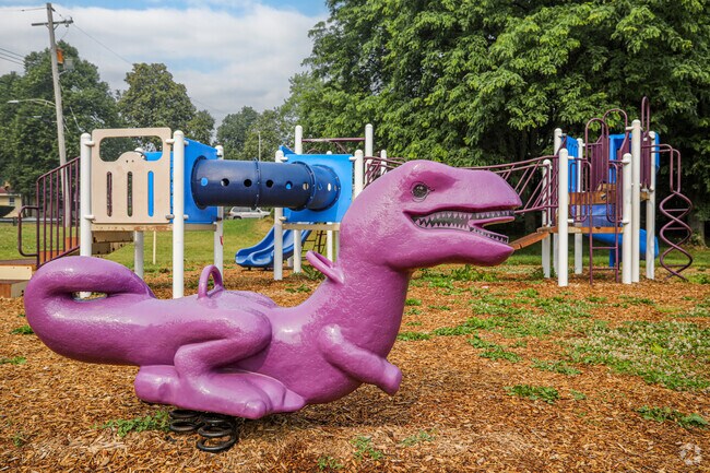 Kids at Bassett Park can go wild on the playground and ride dinosaurs.