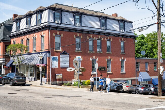 A family is enjoying an outdoor walk on Main Street in Nichols Corner, RI.
