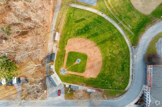 A baseball field is located on the campus of Helen R Donaghue School.