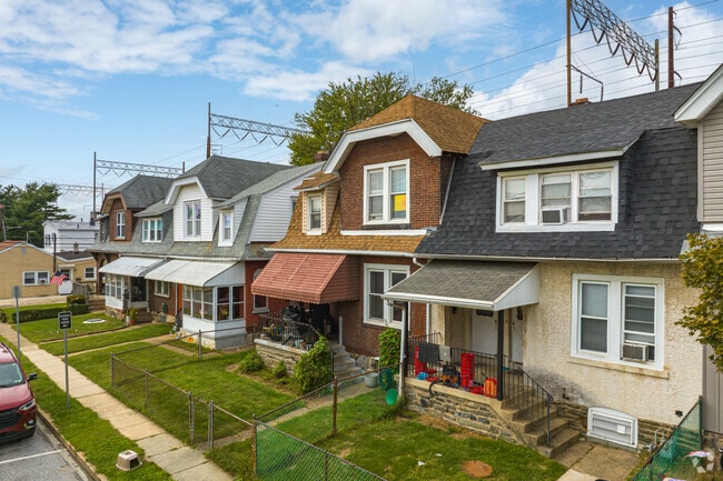 Dutch Colonial styled row homes with small yards fill the residential streets of Trainer.