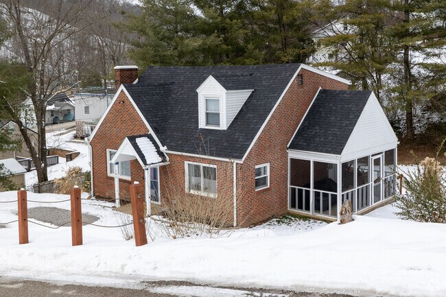 Cozy cape home along the mountain side in Elkview.